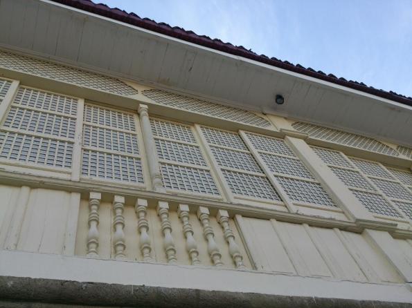 Sliding windows and balustrades of this bahay-na-bato convent that is attached to the church
